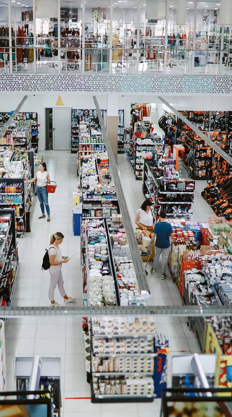 People in front of shelves in a retail store